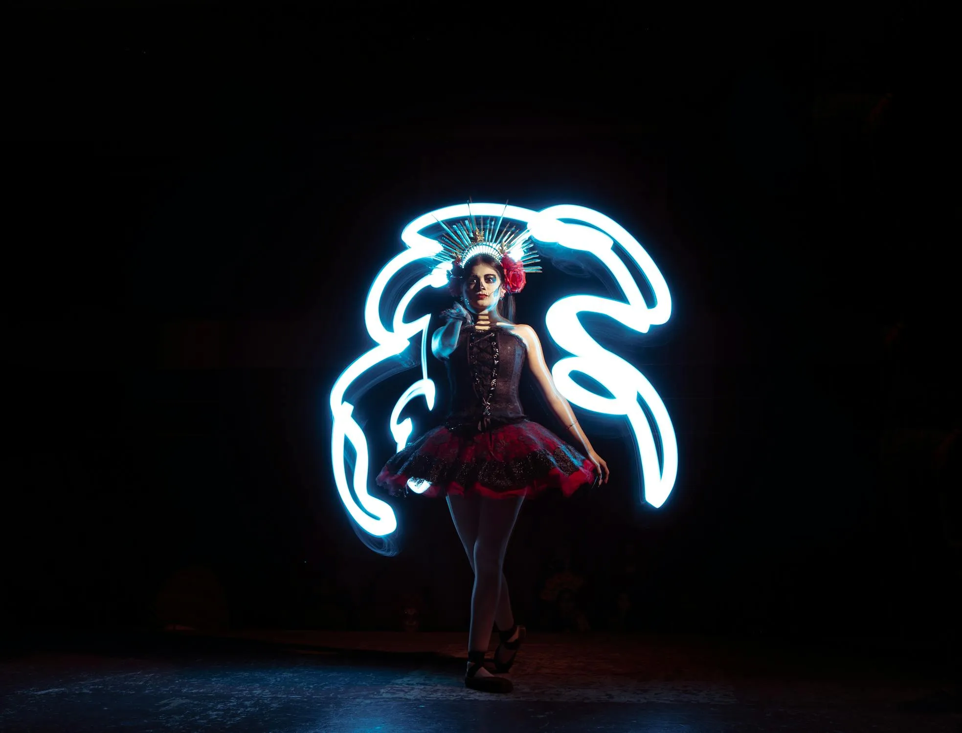 Person Dancing with Neon Light Effects in Dark Room image