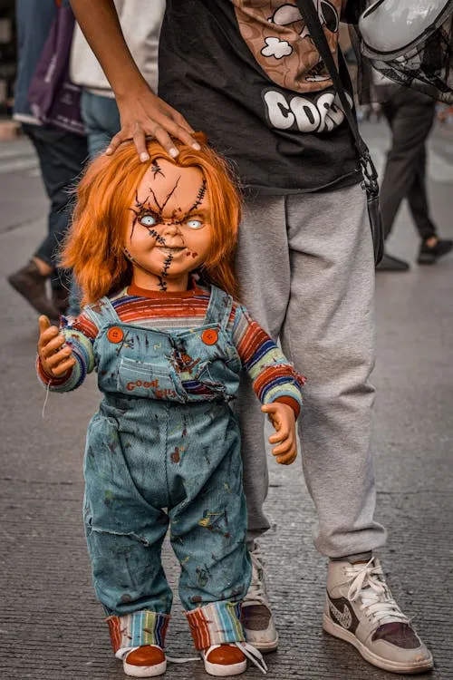 Person holding a Chucky Doll in the Streetwear HD Wallpaper