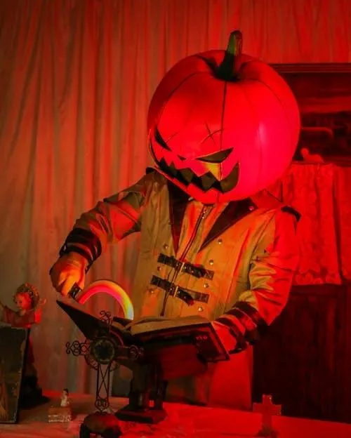 Person in Pumpkin Head Costume Creating Halloween Effect