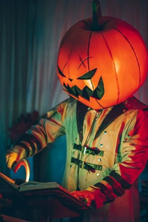 Person in Pumpkin Head with Colorful Halloween Lights