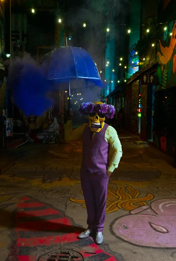 Person in Purple Clown Outfit at Halloween Parade image