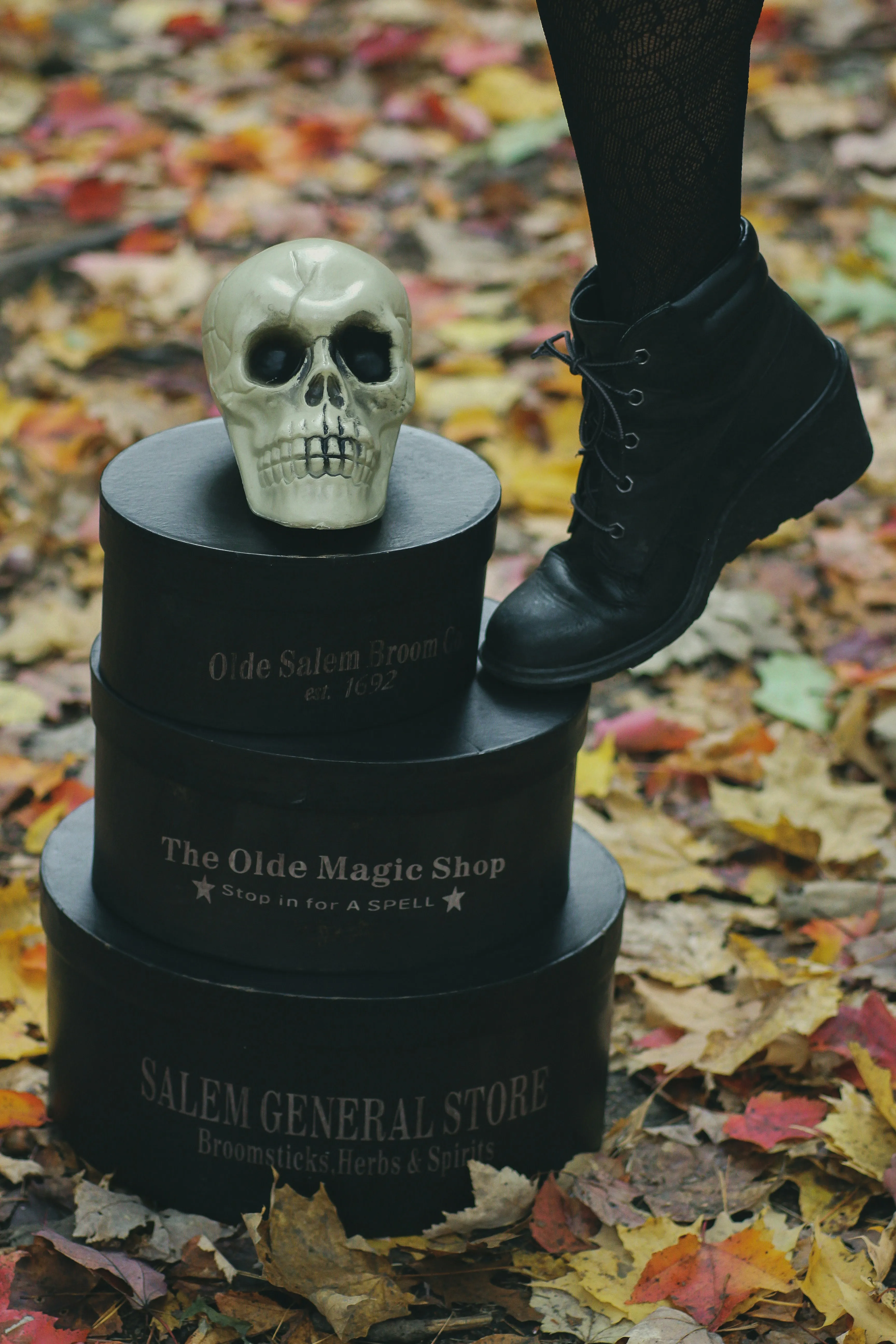 Person Standing on Tombstone with Skull Decoration