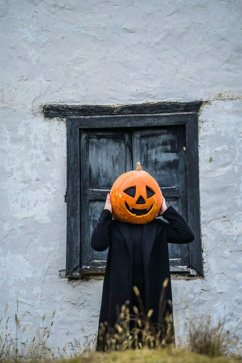 Person Standing with Pumpkin Head in Vintage Setting Wallpaper