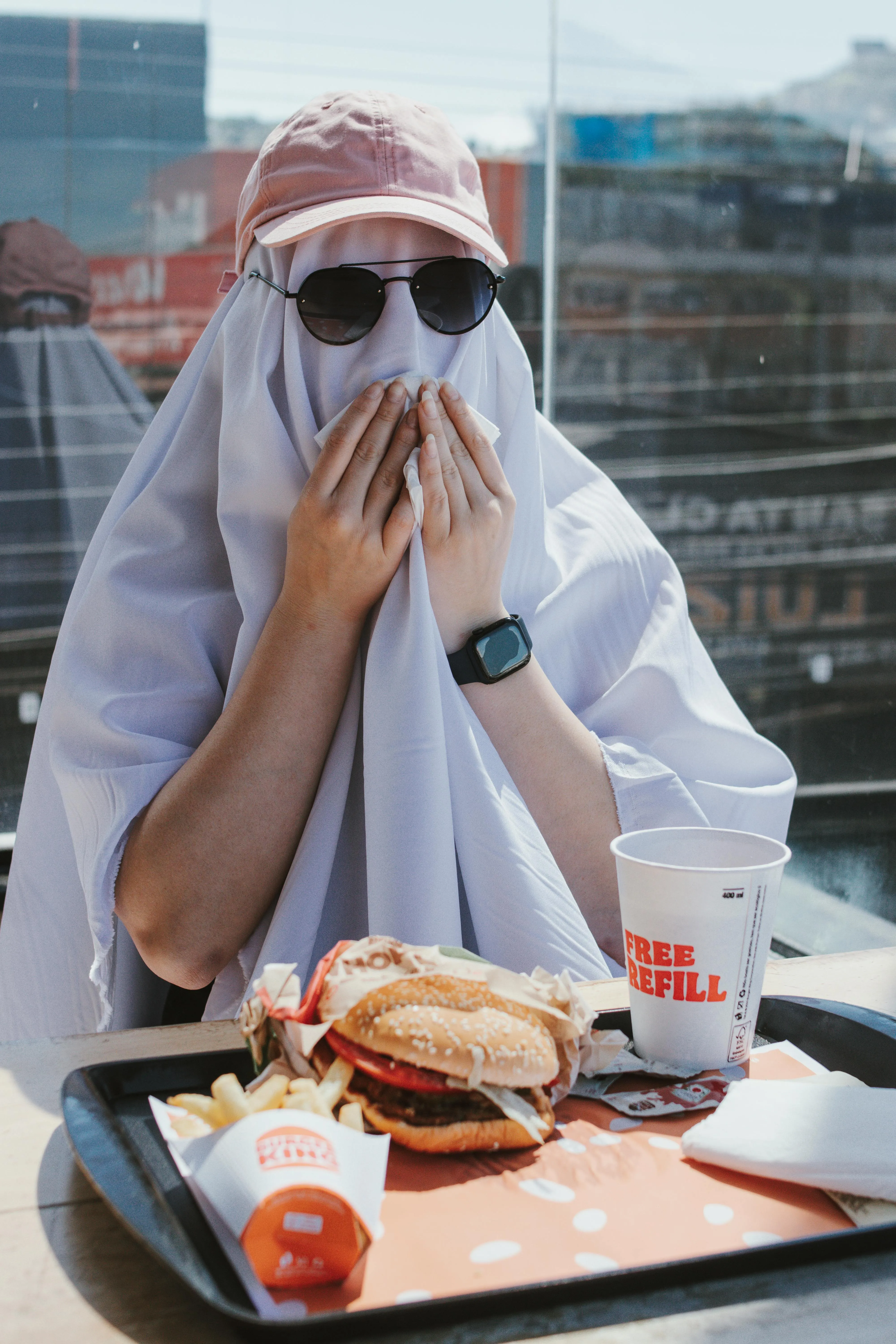 Person Wearing Ghost Costume Eating Fast Food Outdoors