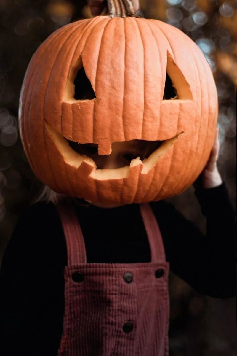 Person Wearing Pumpkin Head at Halloween Festival