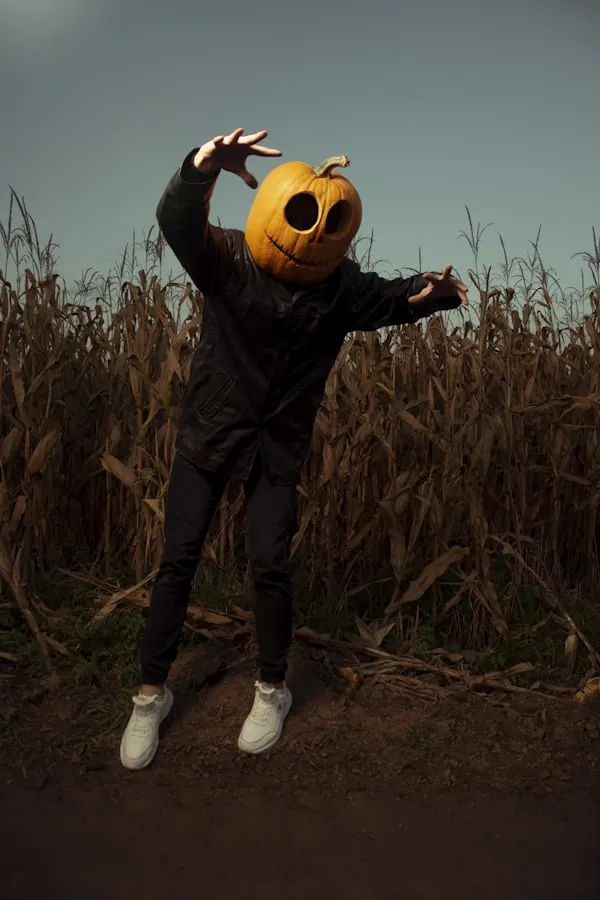 Person Wearing Pumpkin Head in Halloween Field Scene Image
