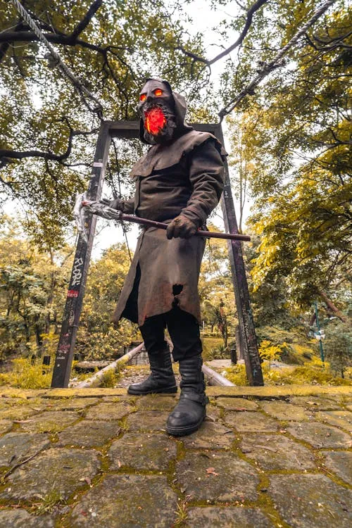 Person Wearing Scary Mask and Axe at Halloween Festival