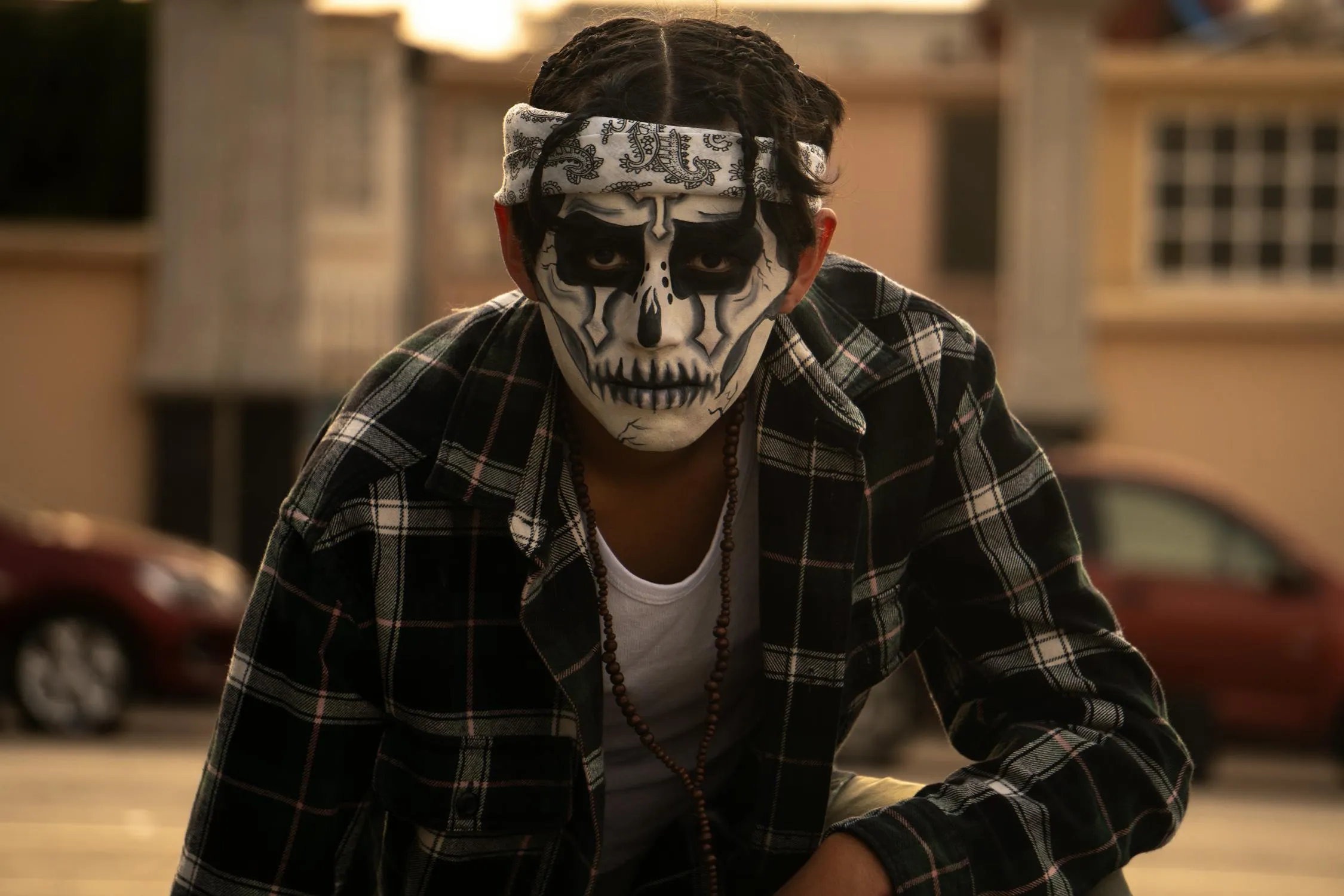 Person Wearing Skull Makeup and Plaid Shirt Outdoors image
