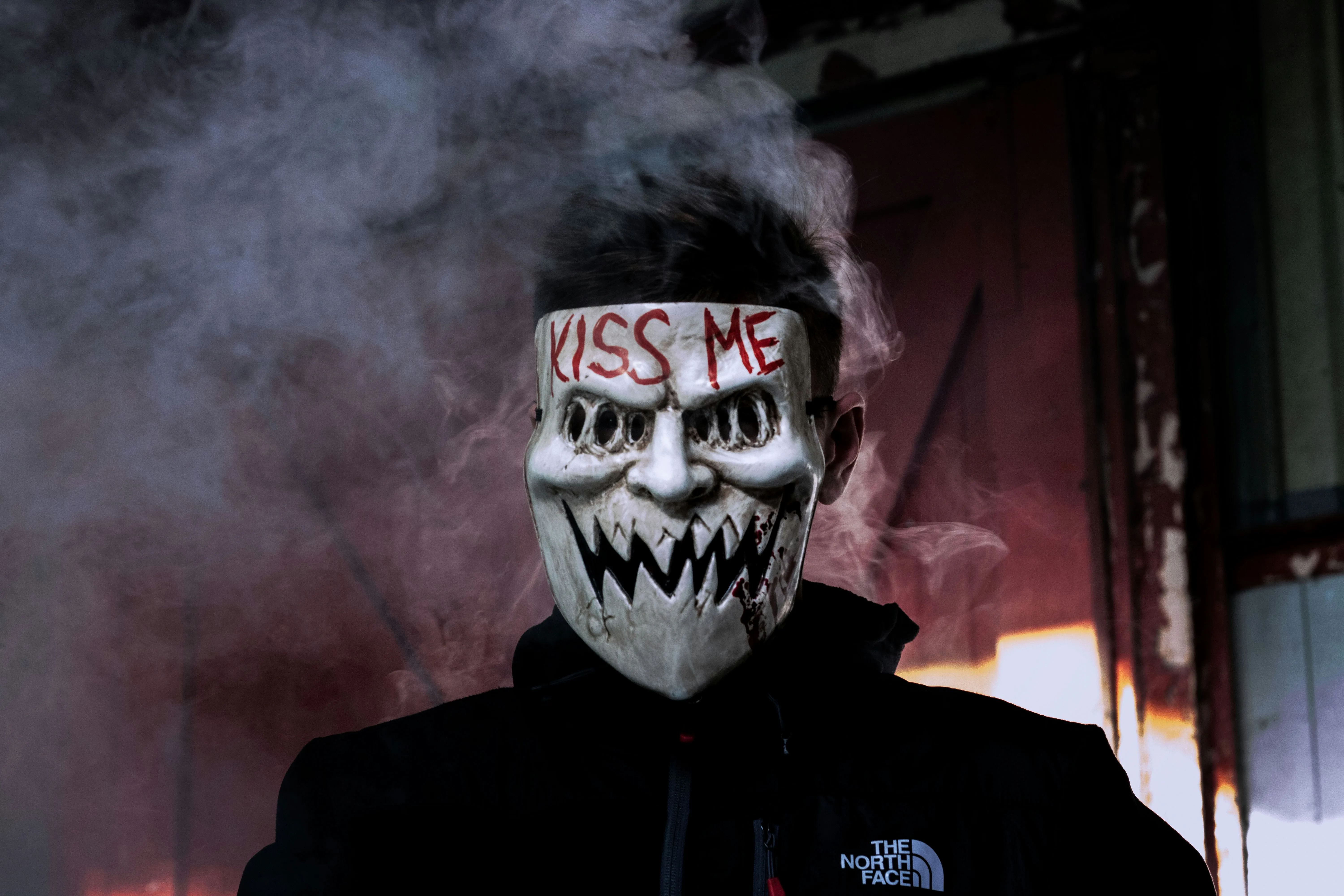Person with Painted Face and Smoking Halloween Mask image