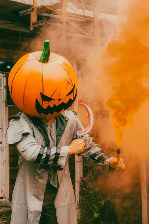 Person with pumpkin head and smoke at Halloween Wallpaper