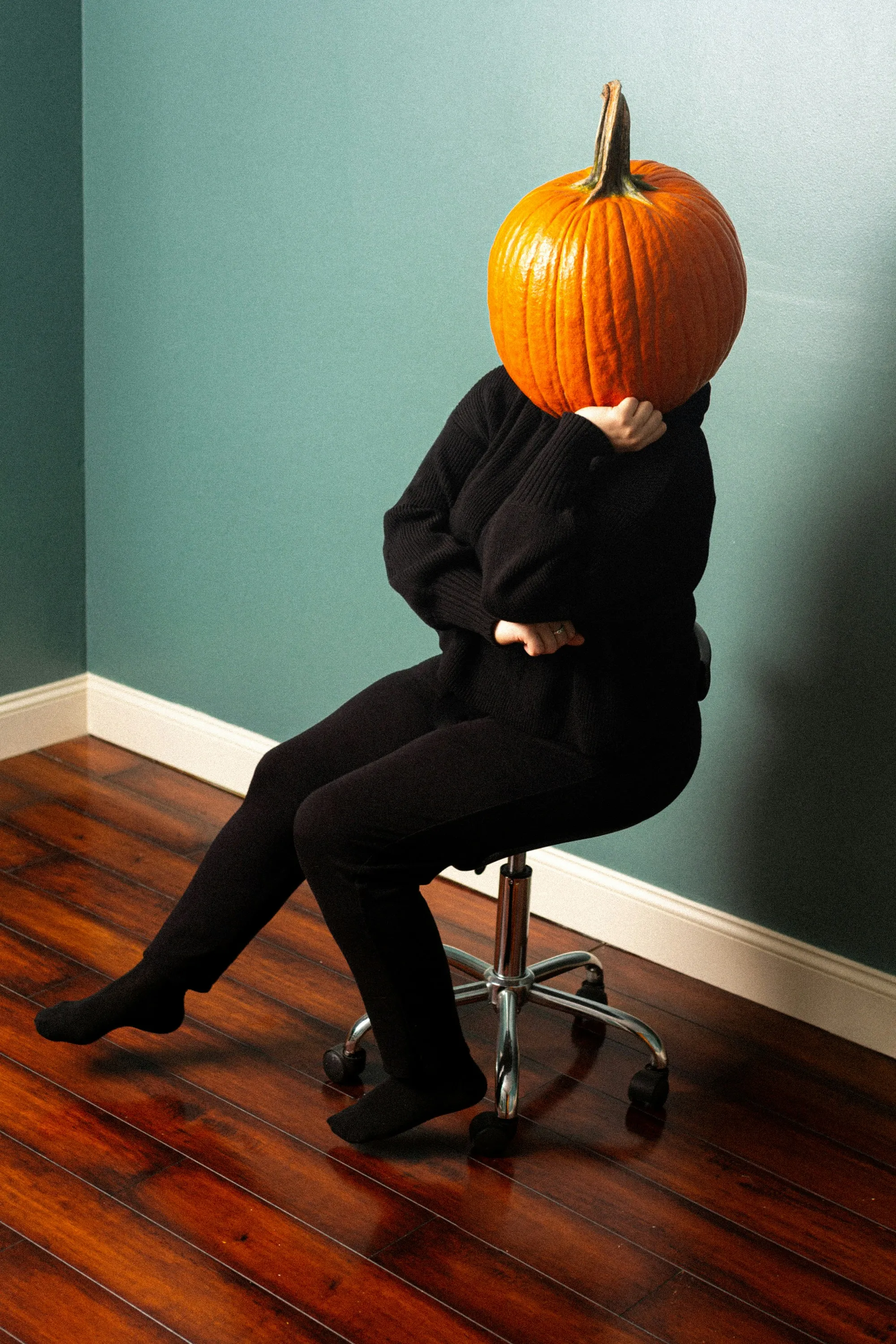 Person with Pumpkin Head Sitting in Modern Office Chair HD