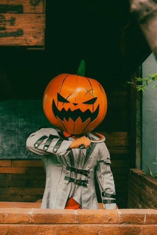 Person with pumpkin head with tool at Halloween festival