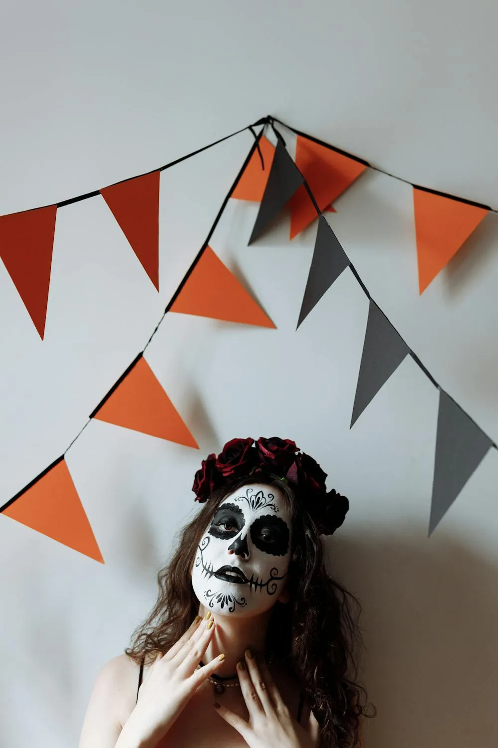 Person with Skeleton Face Paint and Halloween Banner Decor
