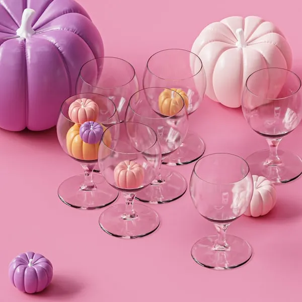 Pink and White Mini Pumpkins in Glassware on Pink Table