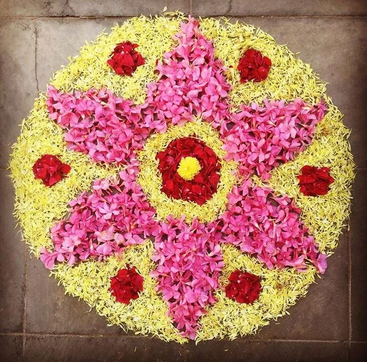Pink star pookolam pattern with yellow circular design image