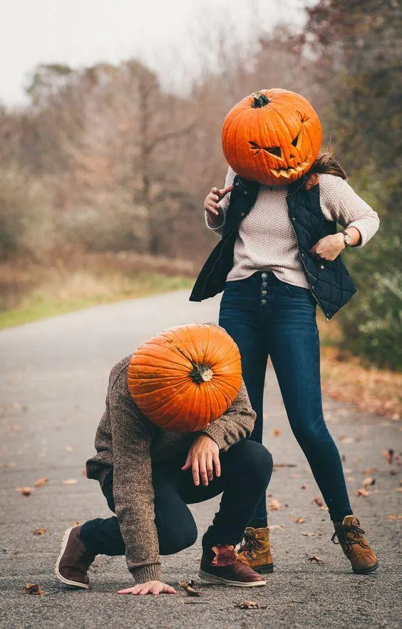 Playful pose of a couple in pumpkin costume HD image