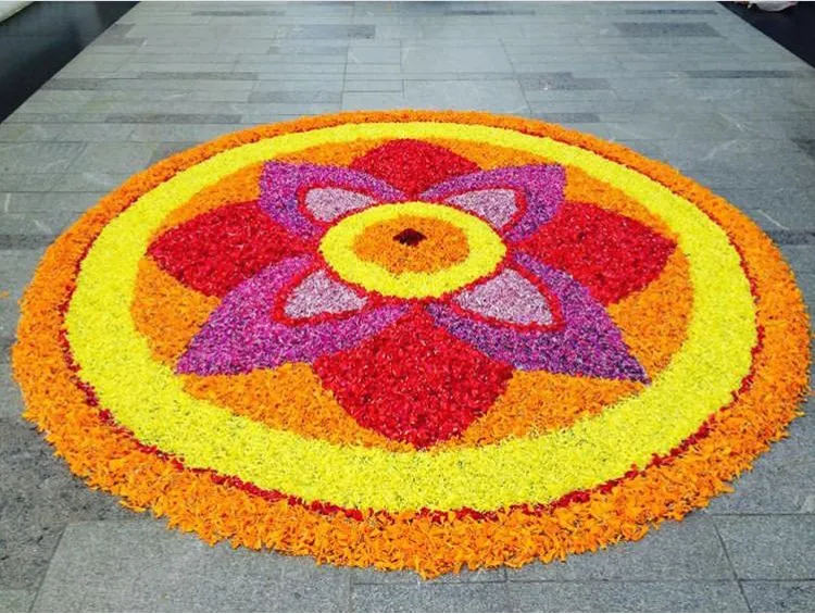 Pookalam with red yellow orange and Purple Floral Patterns