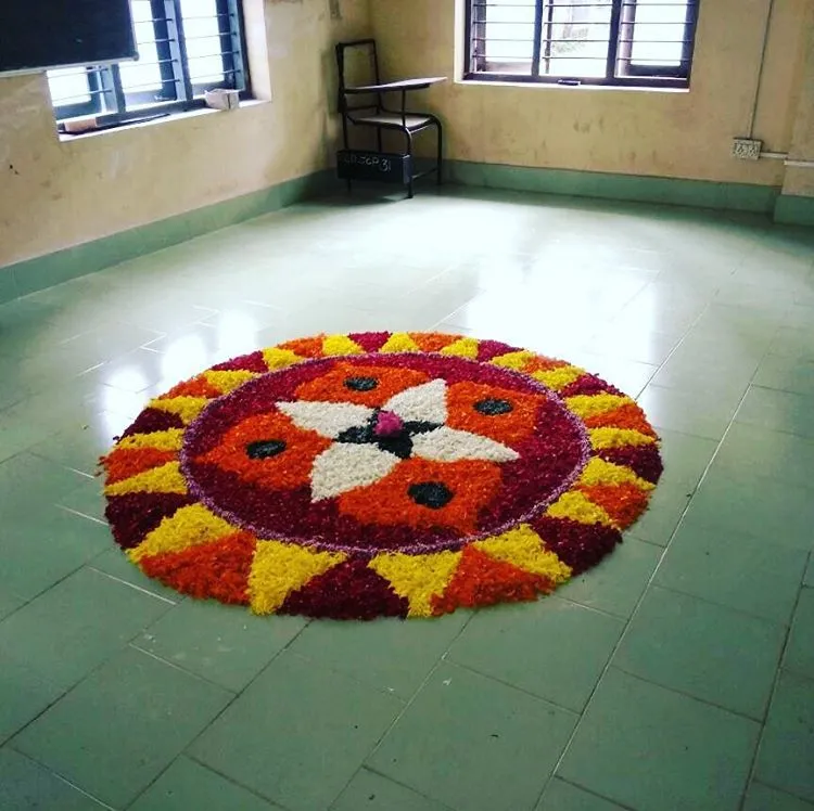 Pookolam with alternative orange and yellow petal design
