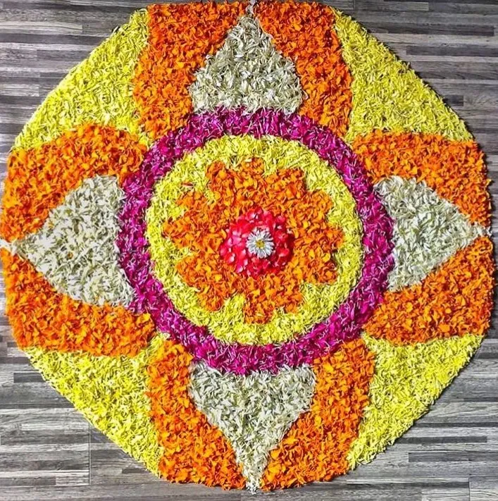 Pookolam with circular and orange and white floral design