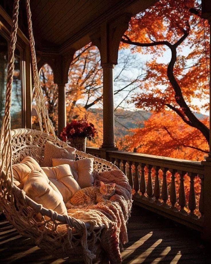 Porch with Rocking Chair Overlooking Autumn Leaves Wallpaper