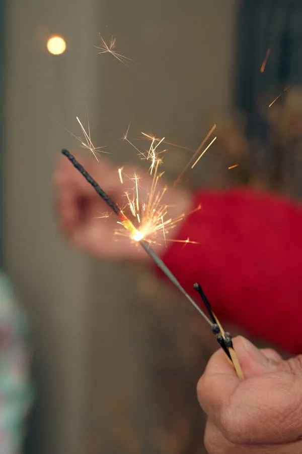 Portrait of Person Holding Sparkler with Glow in the Night