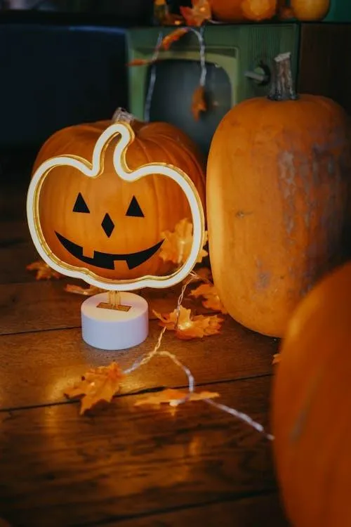 Pumpkin and Candlelit Glass Jar Creating Cozy Halloween Mood