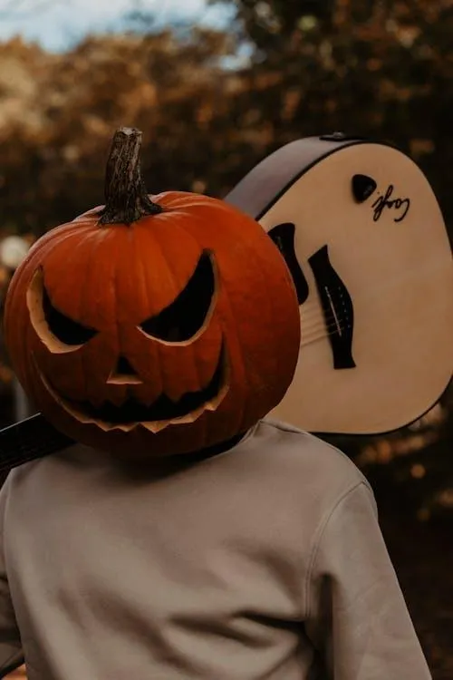 Pumpkin Head Costume with a Guitar Prop for Halloween