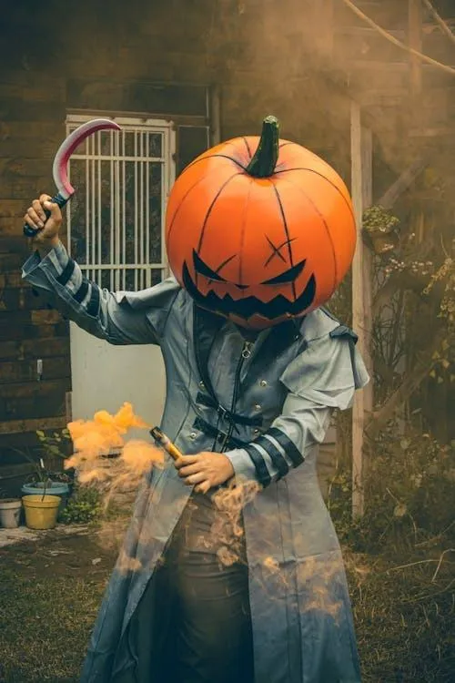 Pumpkin head costume with glowing Halloween smoke