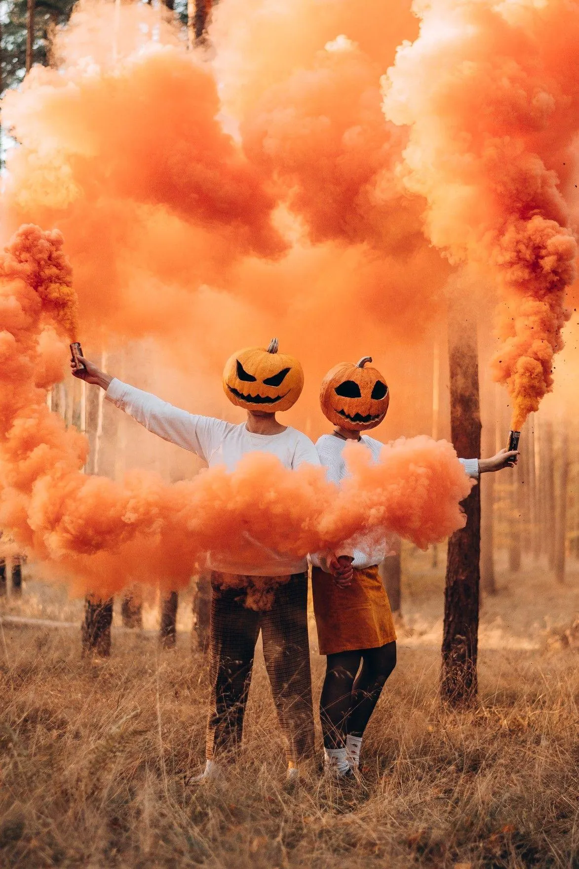 Pumpkin Heads Running Through Orange Smoke Trail Wallpaper