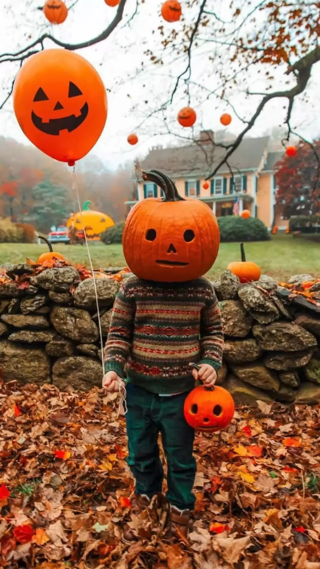 Pumpkin Masked boy with Balloons in Autumn Setting image