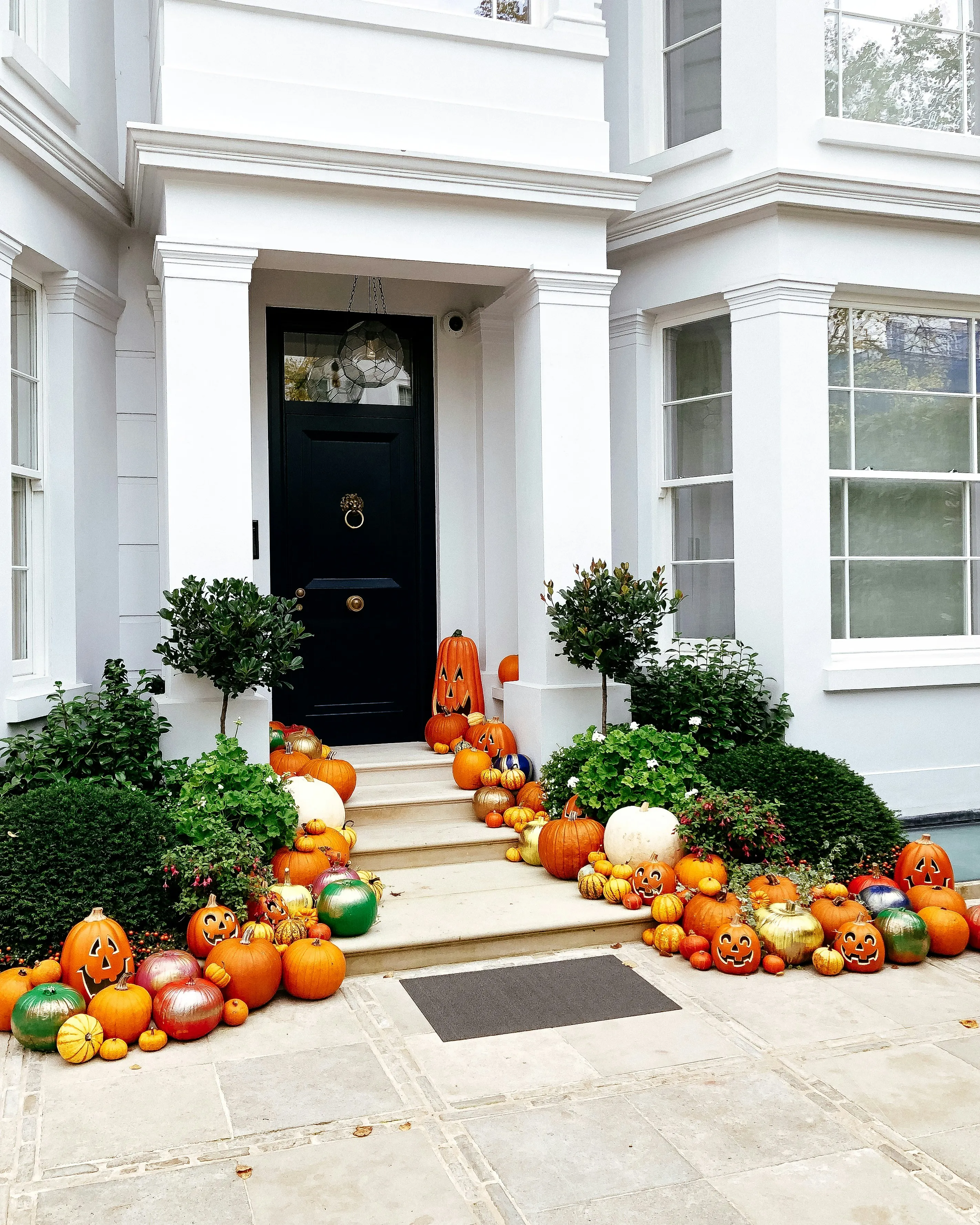 Pumpkins Lining Front Door in Fall Porch Decoration Image