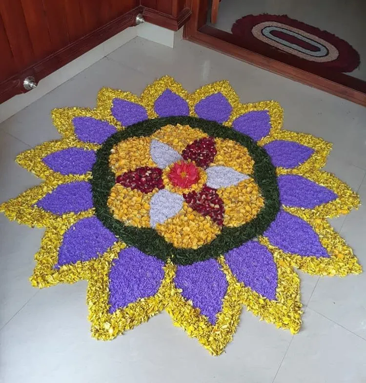 Purple and yellow pookolam for the Onam festival wallpaper