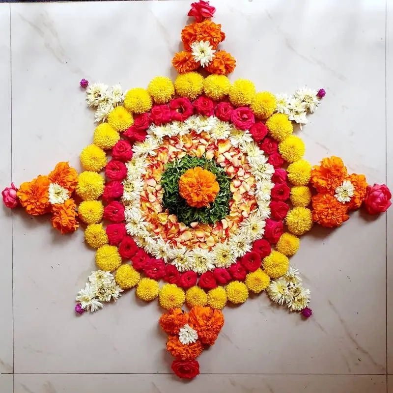 Rangoli with Yellow Orange and Red Flowers Design Wallpaper