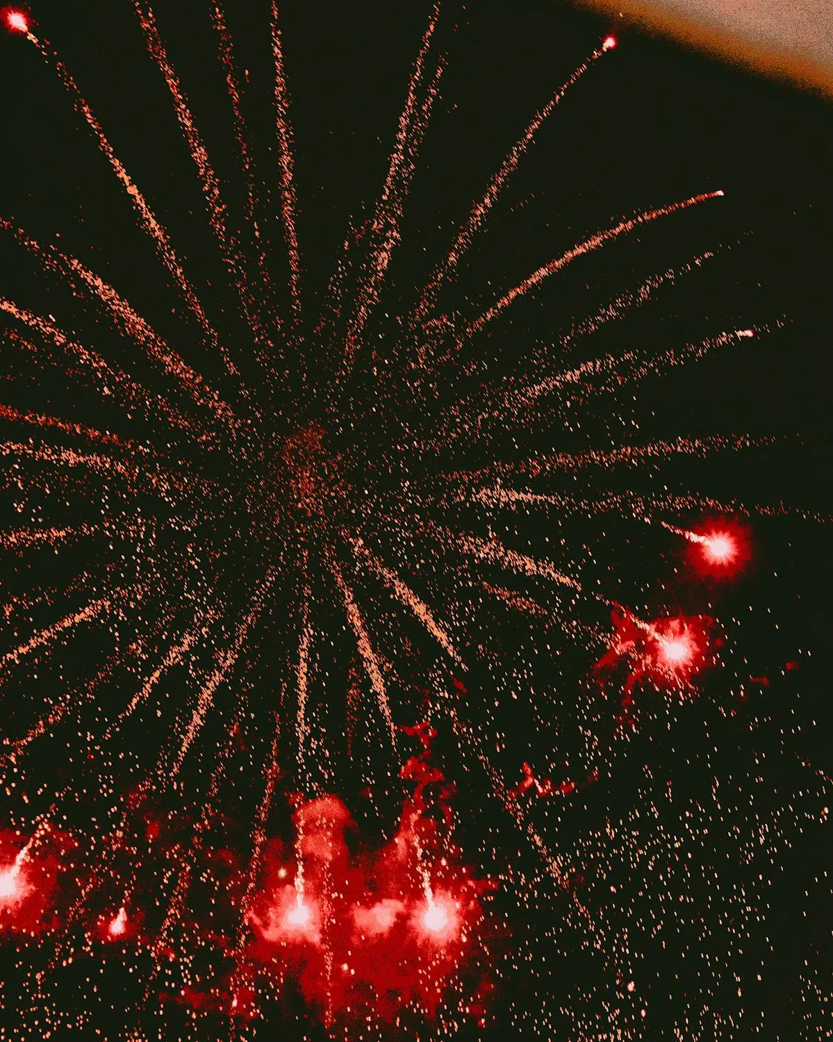 Red and golden fireworks filling the sky during the night