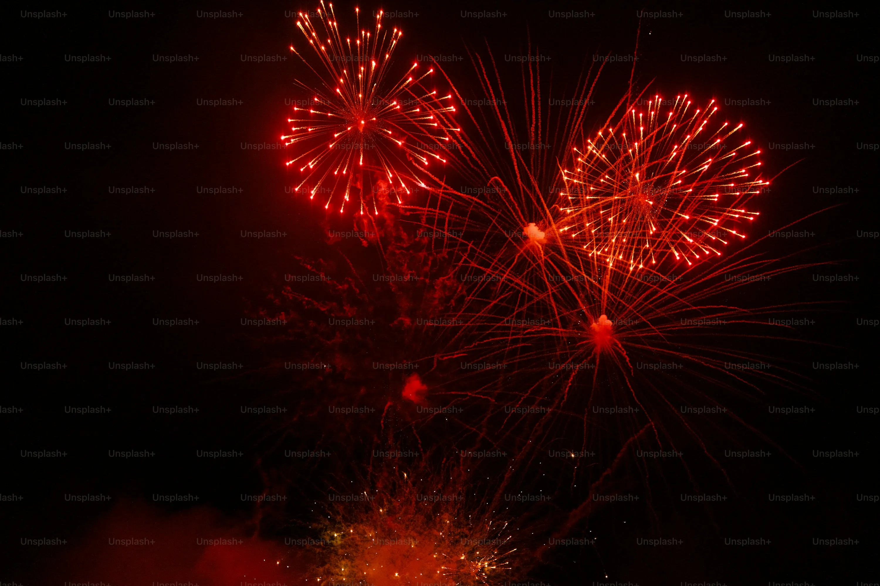 Red and White Fireworks Exploding in the Dark Sky Wallpaper