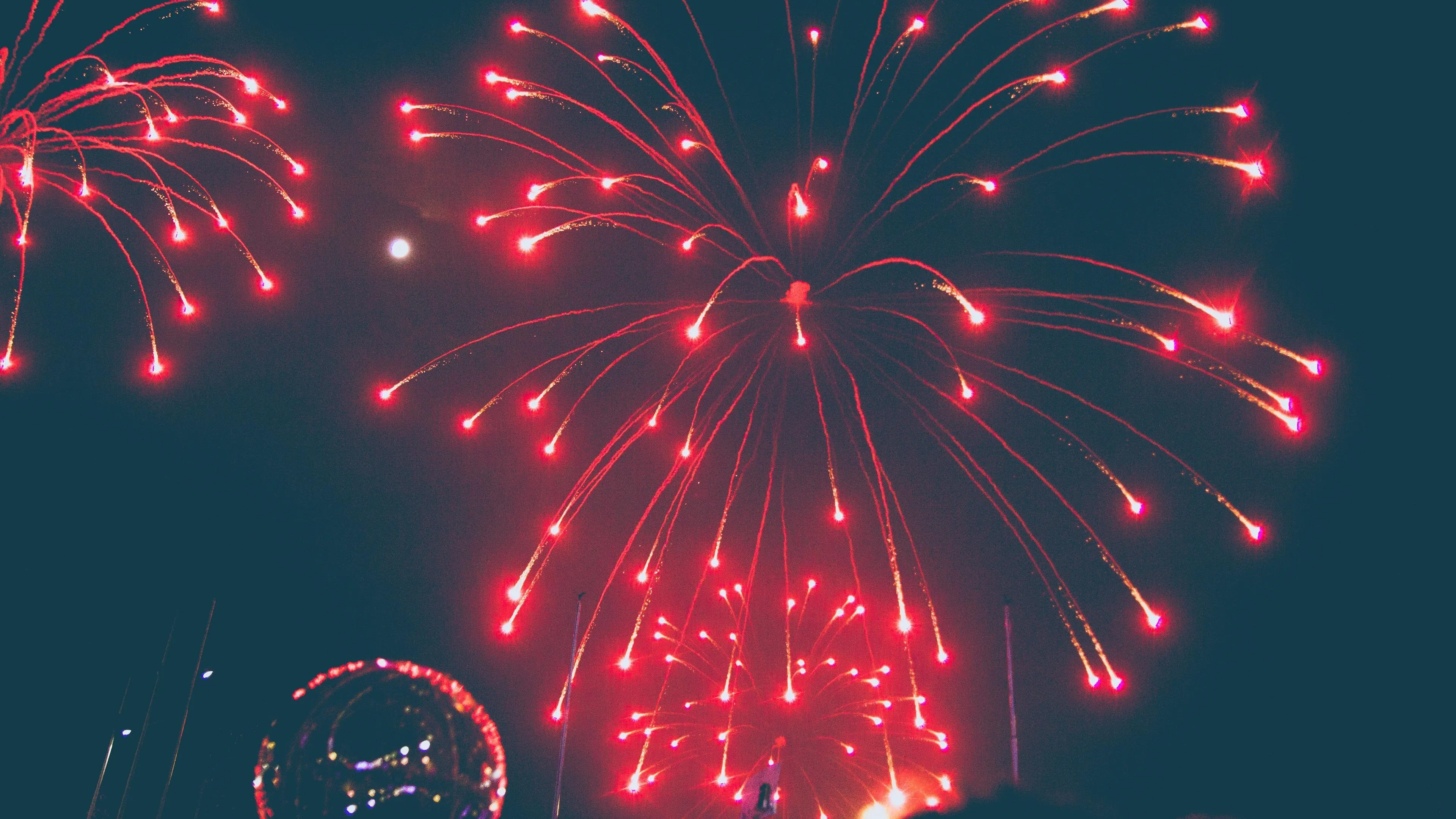 Red and white fireworks sparkling in the evening sky