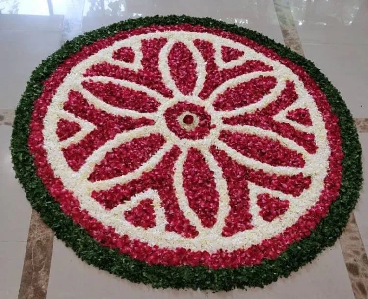 Red and white Onam rangoli with green border free Wallpaper