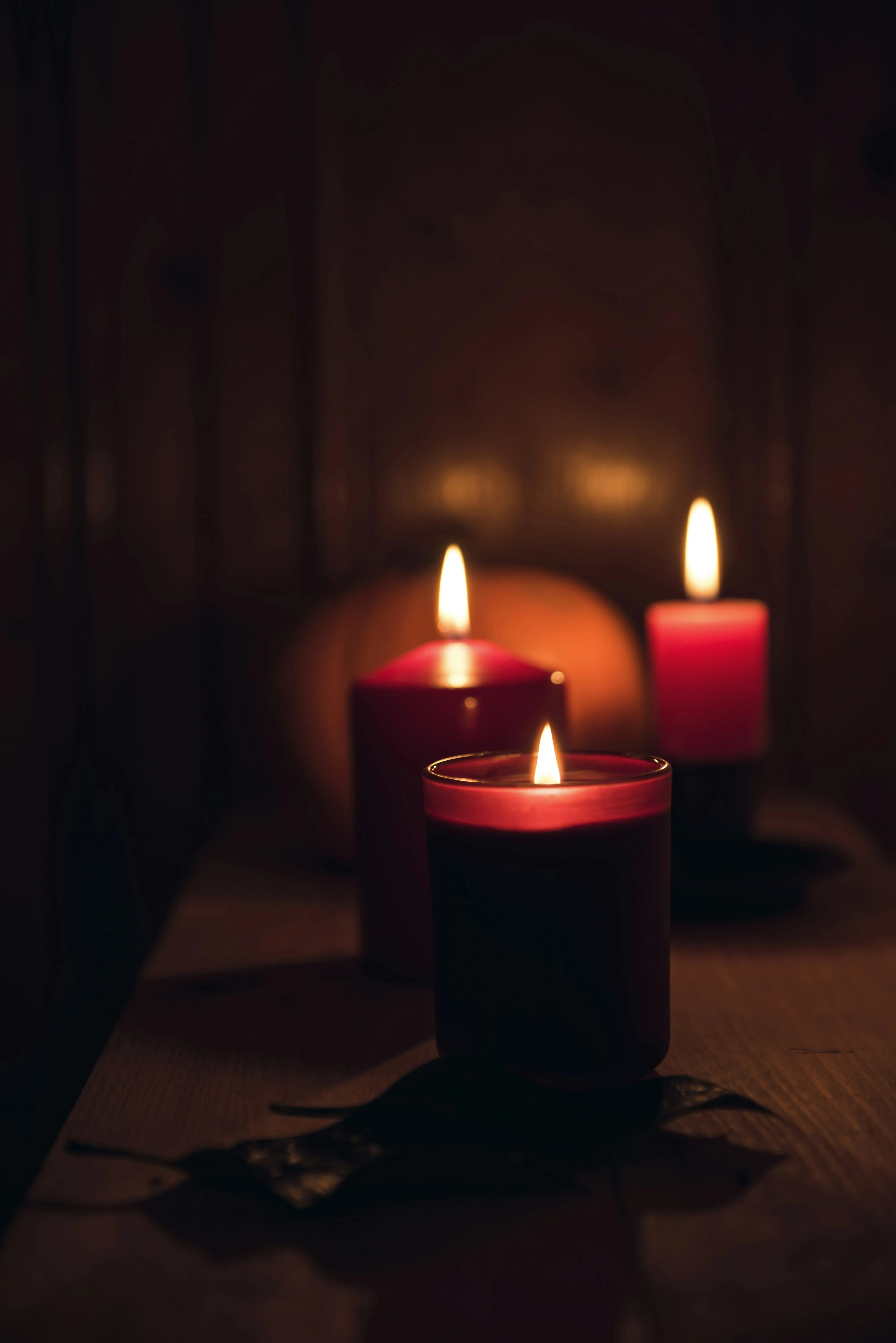 Red Candles Burning in Dimly Lit Room For Halloween Image