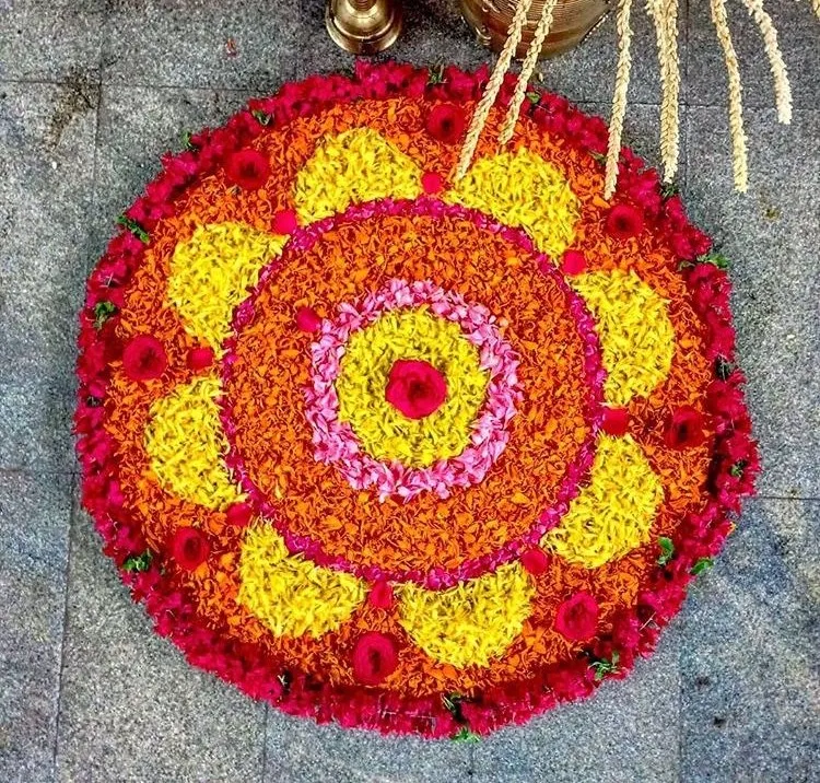 Red circular flower pattern yellow petal design Onam Kolam