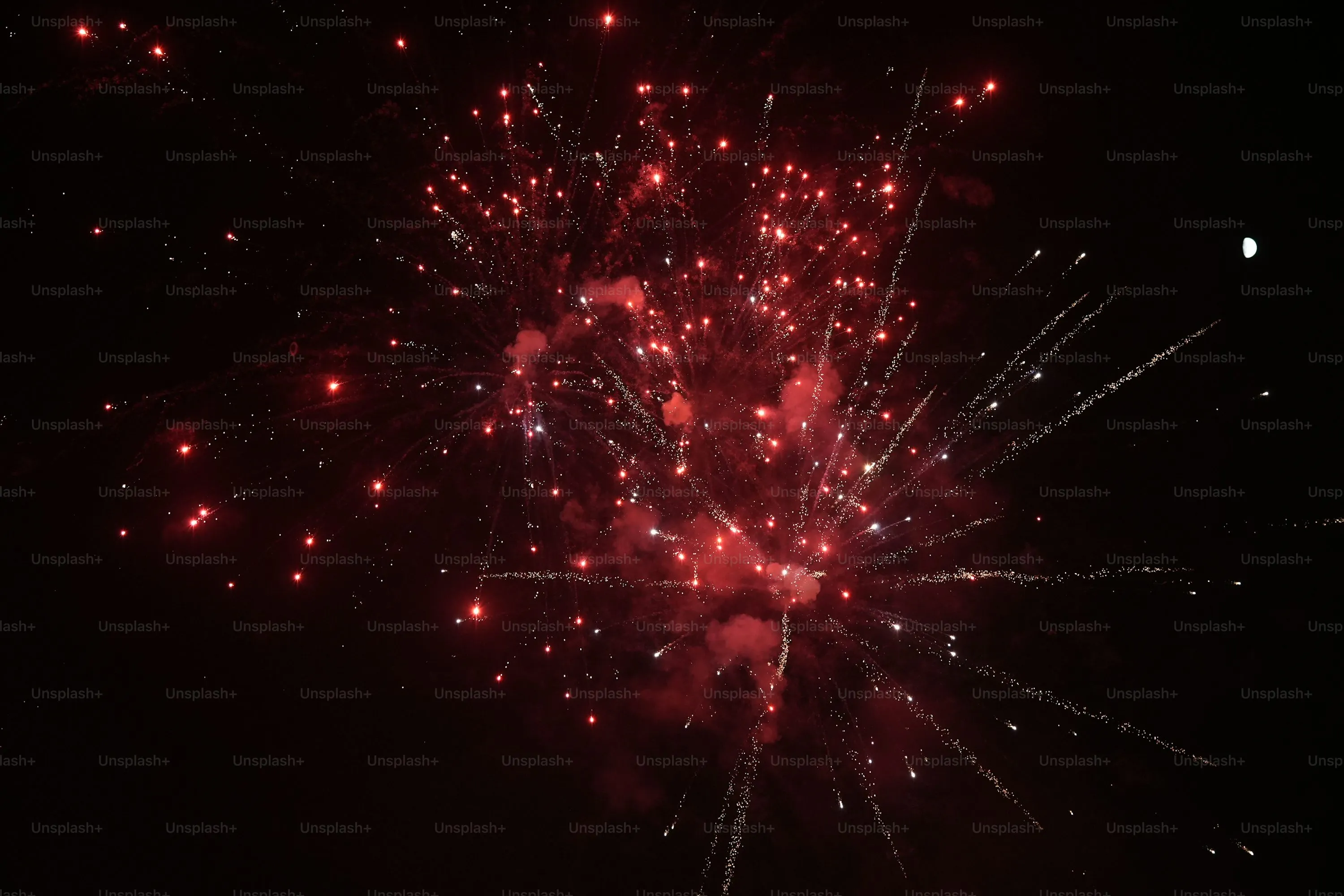 Red Fireworks Glowing Brightly Against the Dark Night Sky