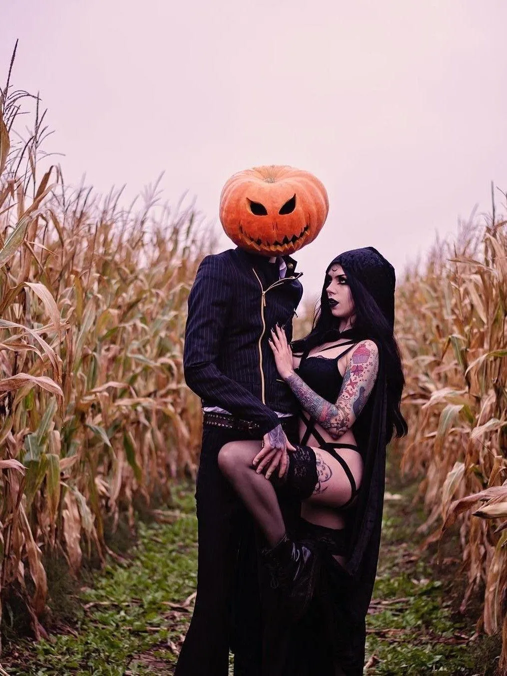 Romantic Halloween Couple with Pumpkin Heads in Field