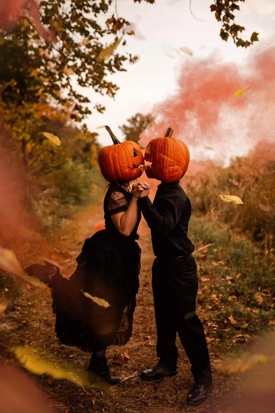 Romantic Pumpkin Head Couple Hugging in Autumn Wallpaper