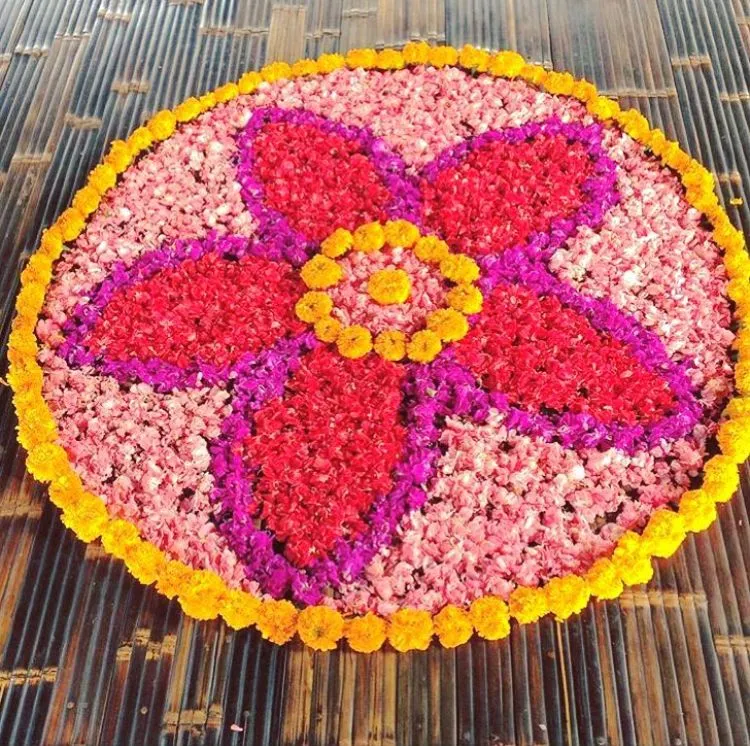 Round vibrant floral pookolam with flower pattern center