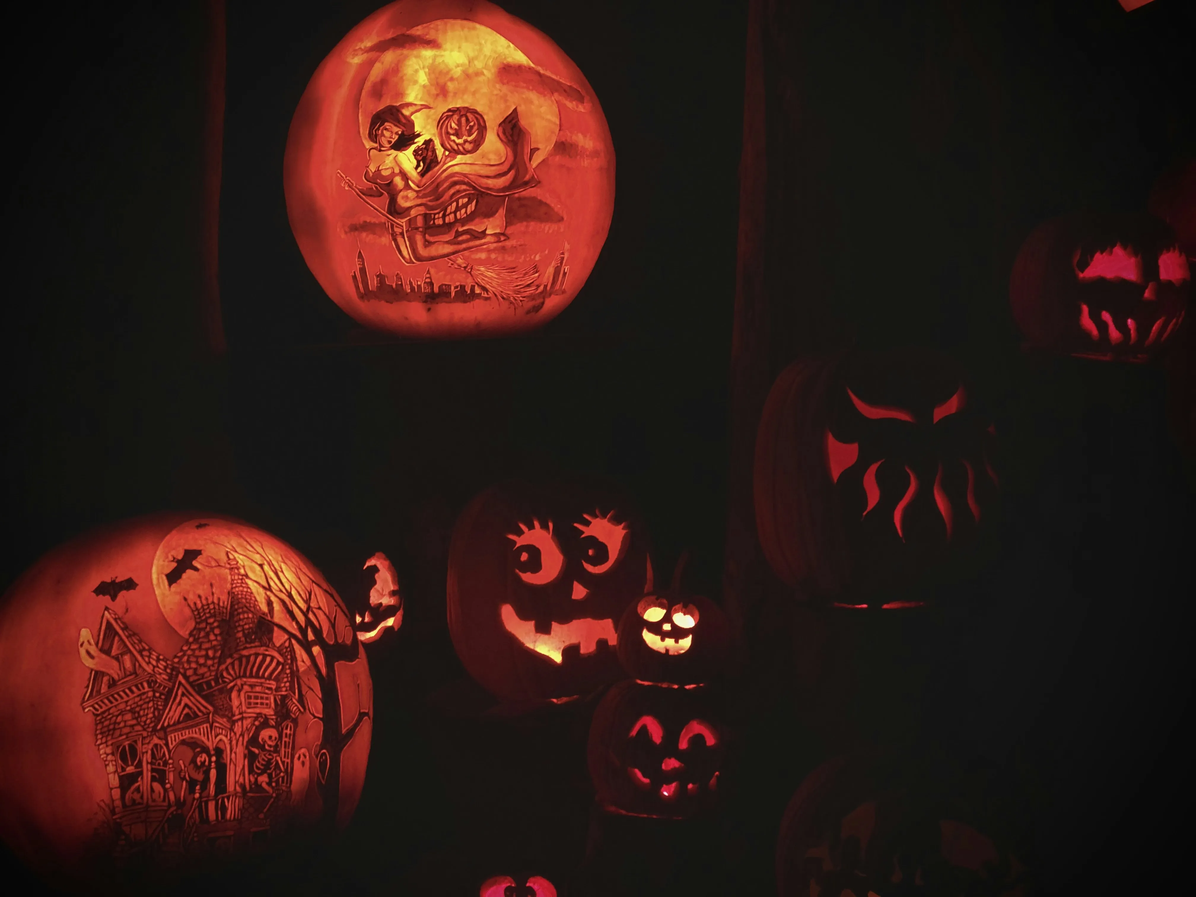Scary Carved Pumpkins with Red Lighting in Darkness Image