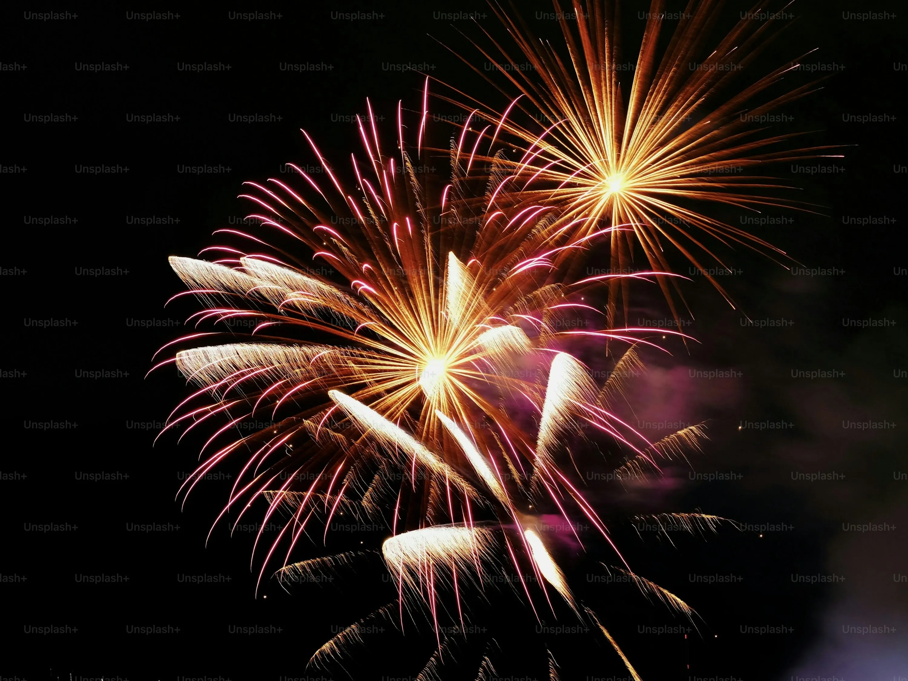 Series of colorful fireworks creating intricate designs