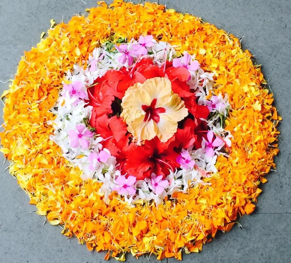 Simple Athapookolam design with Hibiscus and marigolds image