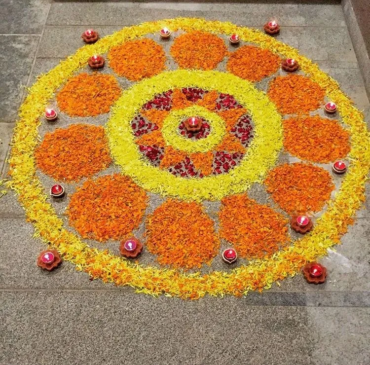 Simple Onam Pookolam Design with yellow and orange petals