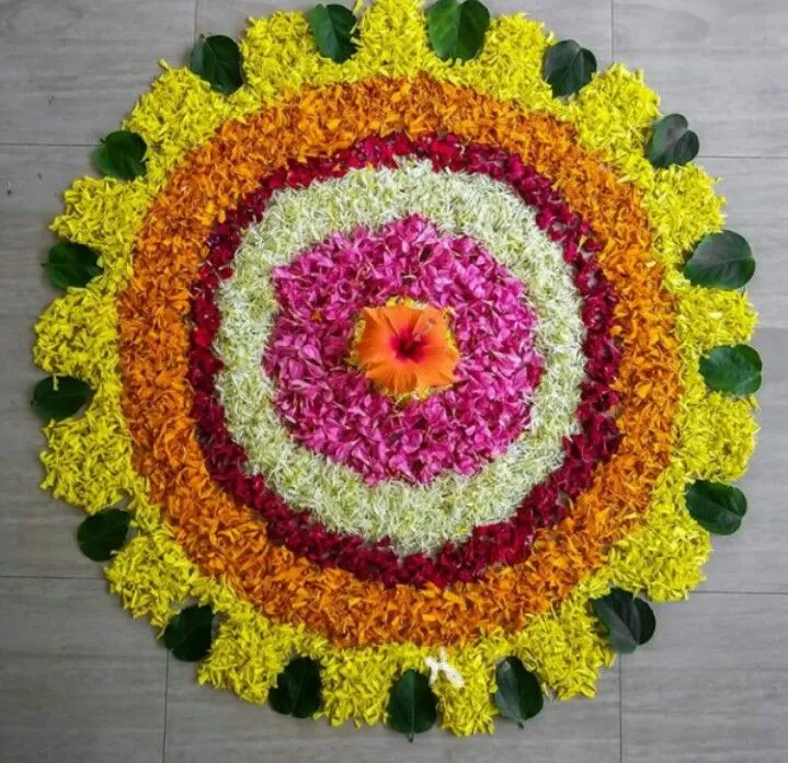 Simple round Pookalam design with colourful petals image