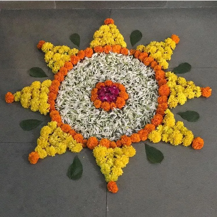 Simple sun shaped Athapookalam Design with marigolds image