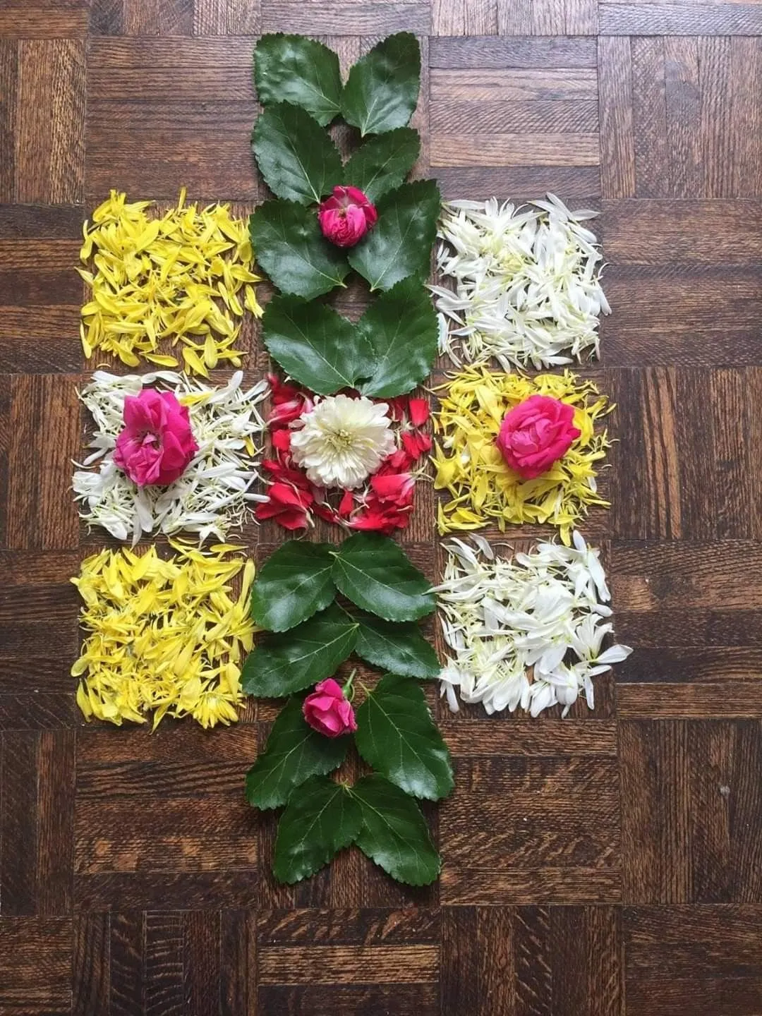 Simple vertical flower kolam with Leaf Centerpiece image